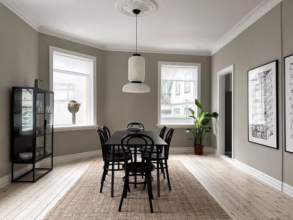 a dining room with a black table and chairs at Design apartments in the heart of Reykjavik in Reykjavík