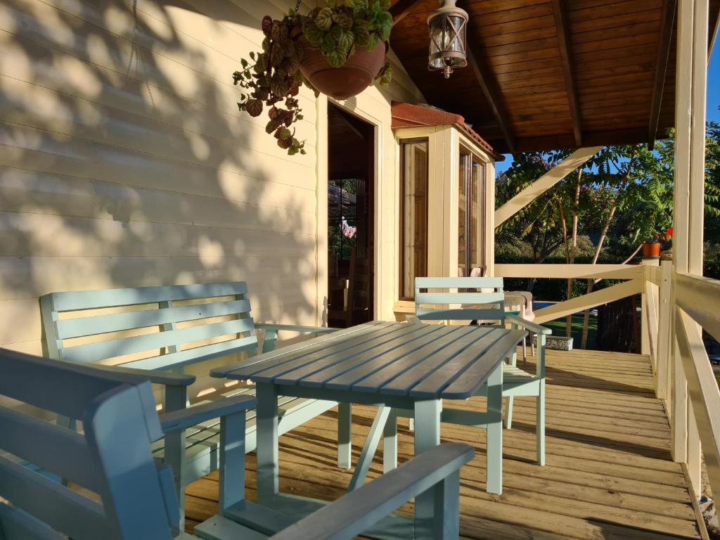 a blue picnic table and chairs on a porch at La casita de madera Sijuela in Ronda