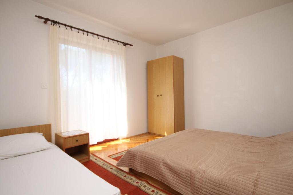 Posteľ alebo postele v izbe v ubytovaní Apartment Vrboska 8748a