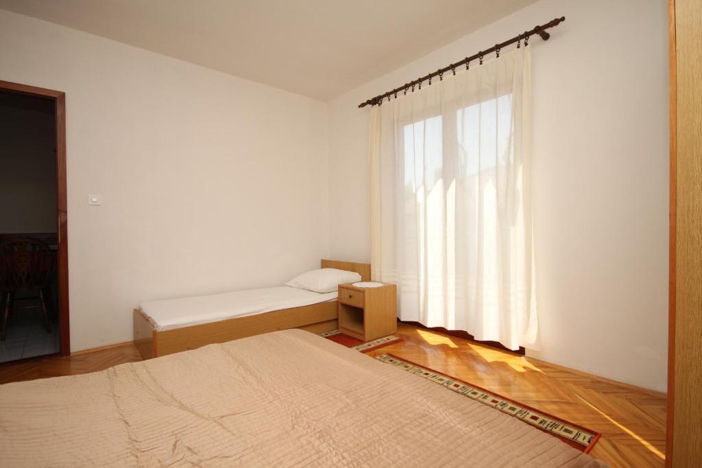 Posteľ alebo postele v izbe v ubytovaní Apartment Vrboska 8748a