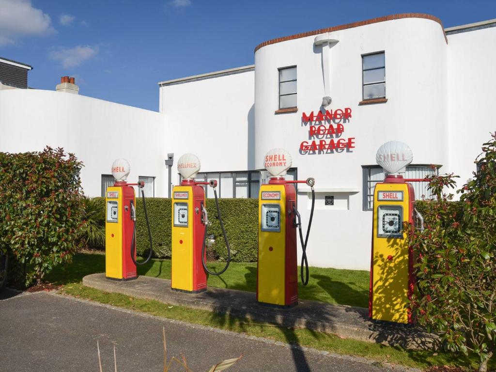 a row of old fashioned gas pumps in front of a building at The Beach Stop in East Preston