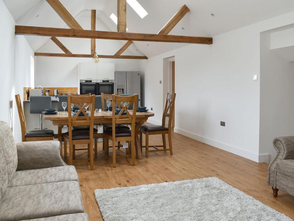 a kitchen and dining room with a table and chairs at Chapel Farm Barn in Smeeth