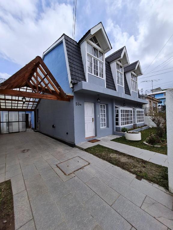 a large white house with a large driveway at CORTEZ CASA in Ushuaia