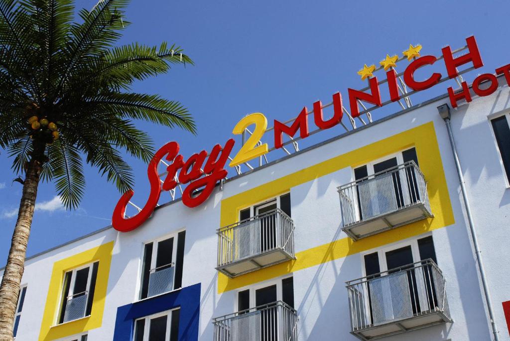 a building with a sign that reads subway million at Stay2Munich Hotel & Serviced Apartments in Brunnthal