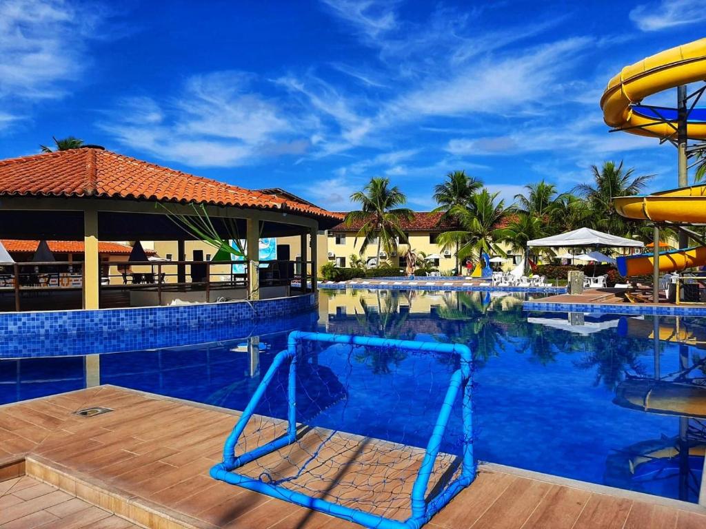 a pool at a resort with a slide at JL Temporadas - Quarto Portobello Park Hotel in Porto Seguro