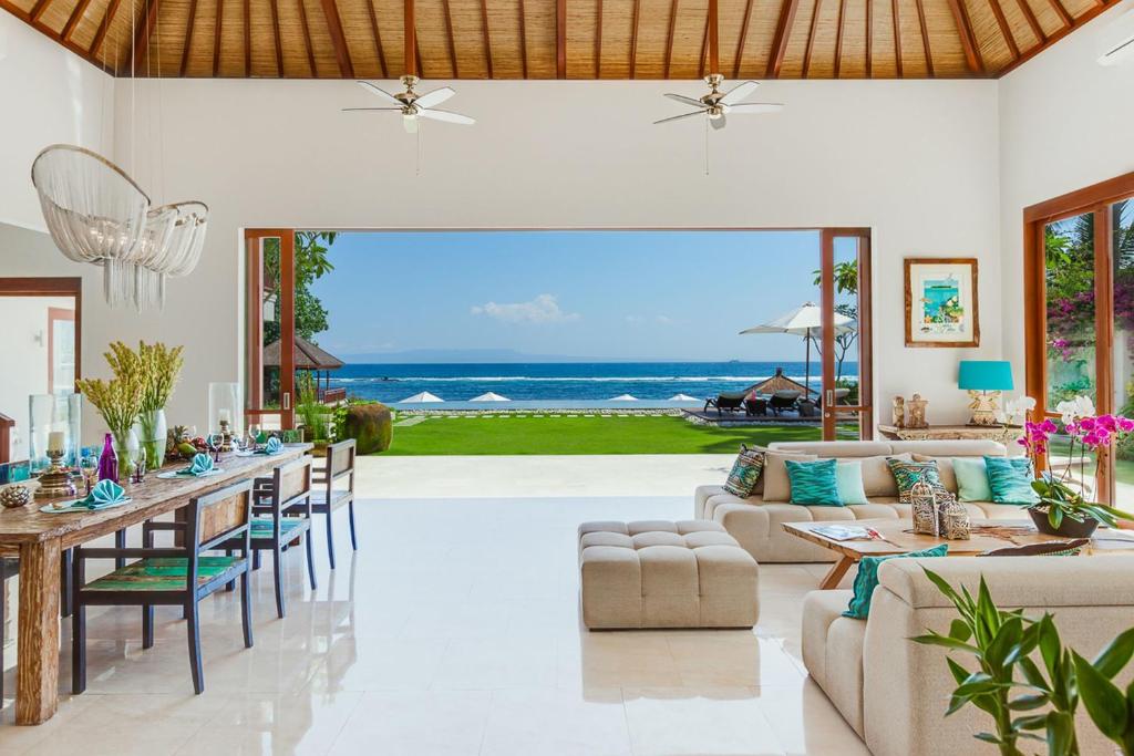 a living room with a view of the ocean at Villa Tirta Nila by Elite Havens in Candidasa