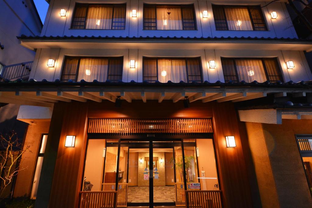 um edifício com a porta da frente iluminada à noite em Nikko Tokinoyuu em Nikko