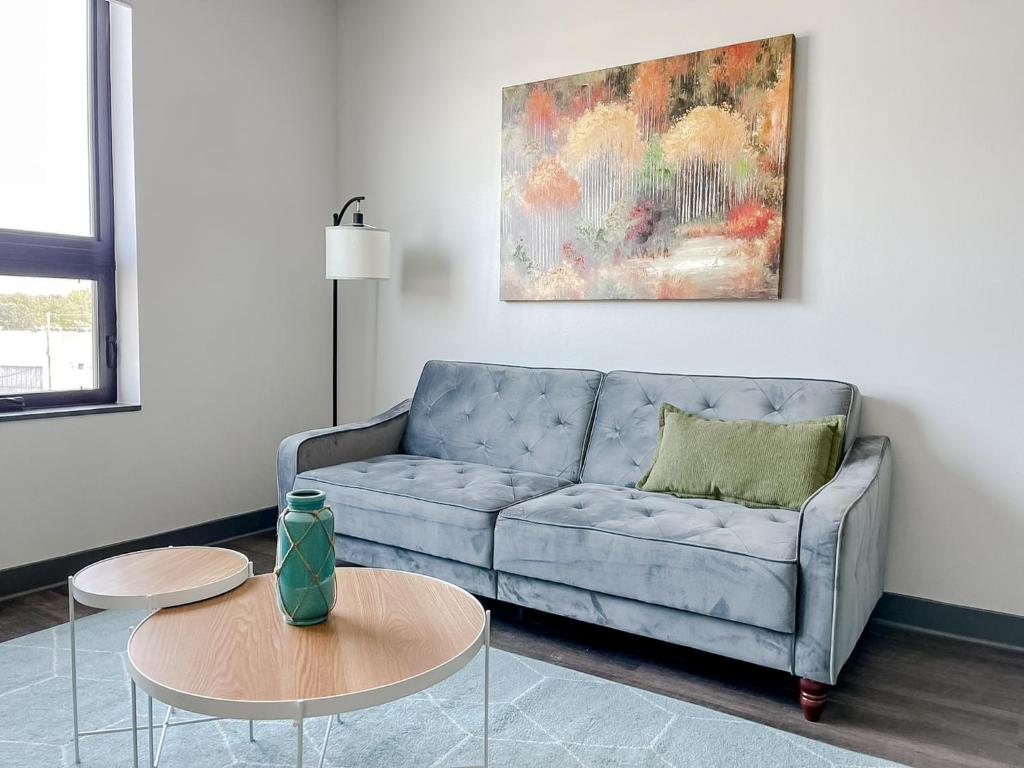 デモインにあるSleepover 1BD 1BA Des Moines Apartmentsのリビングルーム(青いソファ、テーブル付)