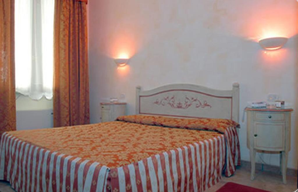 Postel nebo postele na pokoji v ubytování Hotel Adda