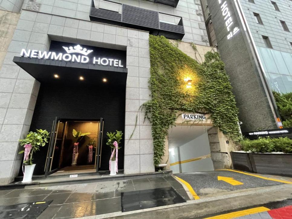 a luxury hotel with a sign on the front of a building at Newmond Hotel in Seoul