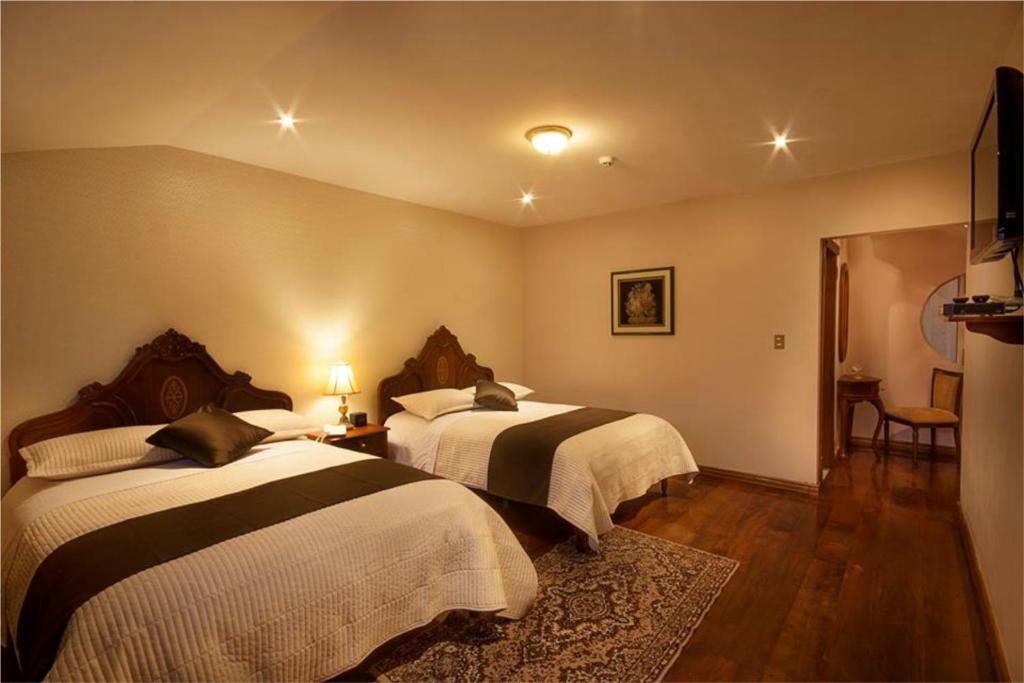 Postel nebo postele na pokoji v ubytování Villa Emilia Hostal