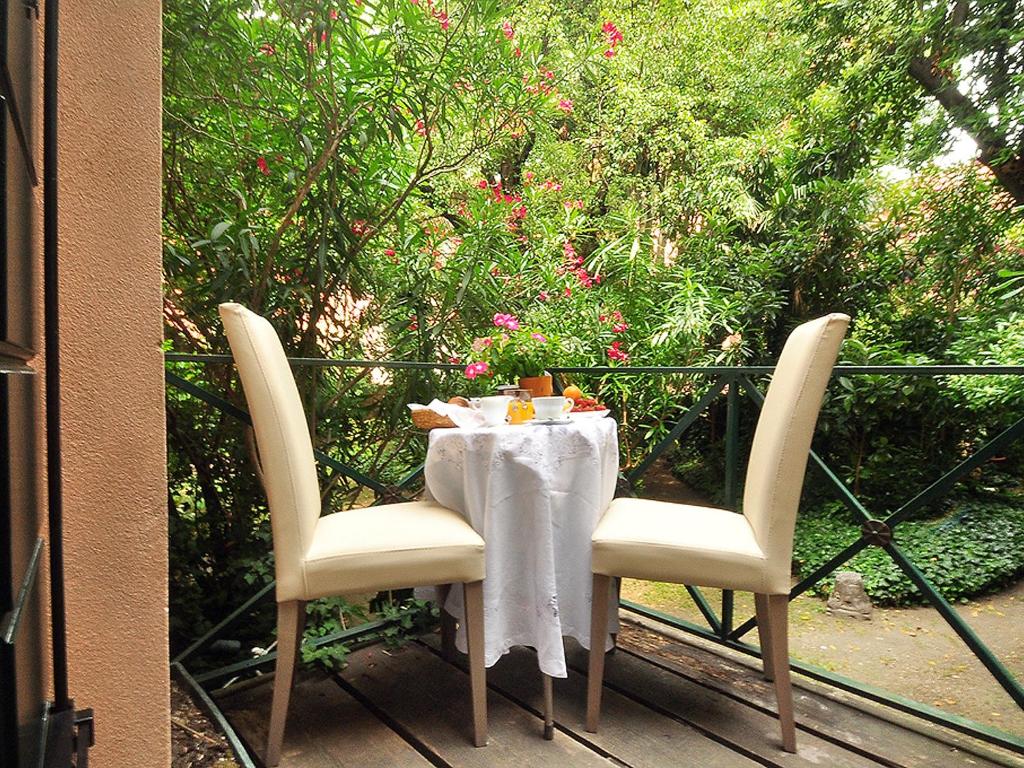 a table with a white table cloth and two chairs at La Casa del Mercante Veneziano in Venice