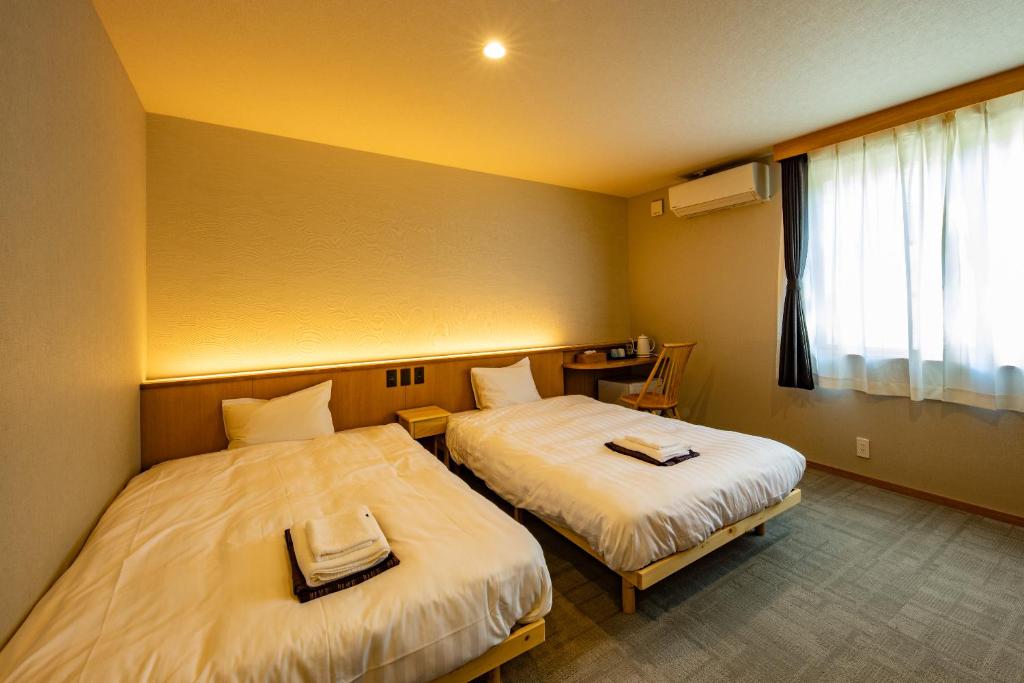 Letto o letti in una camera di CURIO Shirakawago