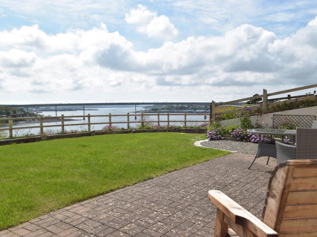 a patio with a bench and a view of the ocean at The Hays in Burton