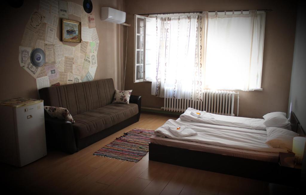 a living room with a bed and a couch at Serdika Rooms in Sofia