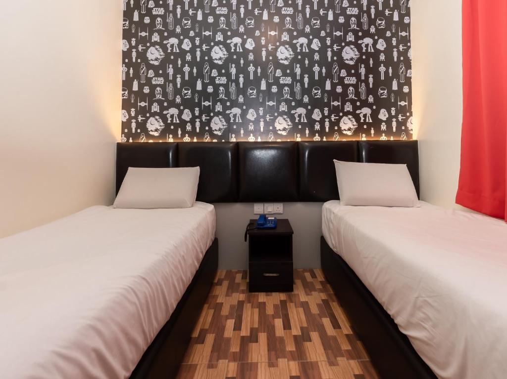 Postel nebo postele na pokoji v ubytování Gold City Hotel