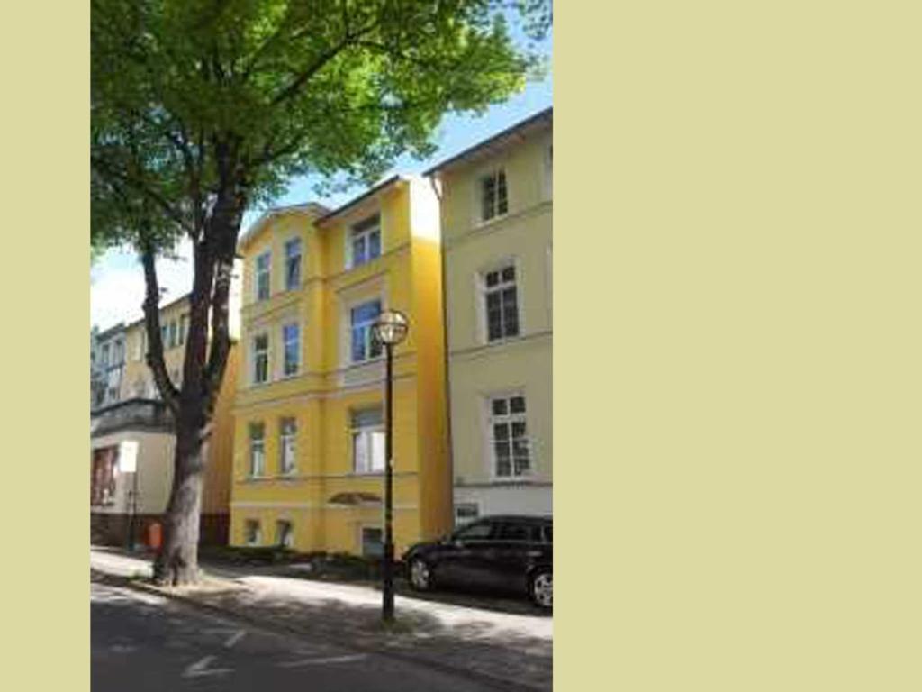 ヴァーネミュンデにあるFerienwohnung Diekelmann _ Poststrの通路脇の黄色い建物
