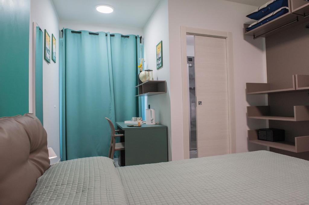 a bedroom with a bed and a table in a room at B&B Lough in Colà di Lazise