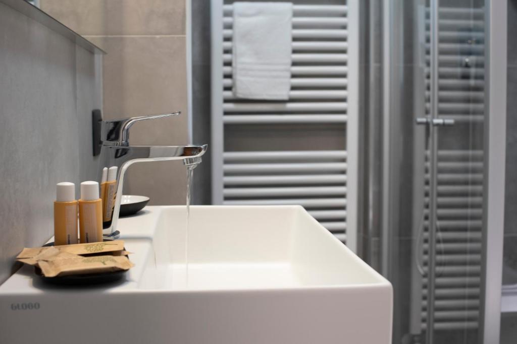 a bathroom with a white sink and a shower at B&B Lough in Colà di Lazise