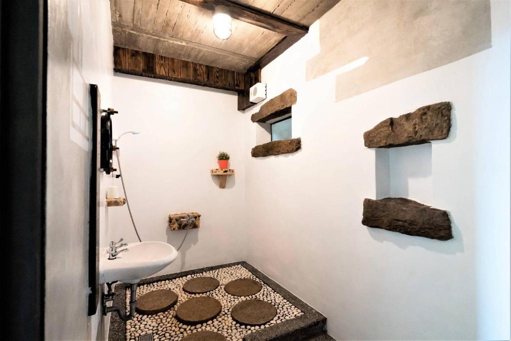 a bathroom with a toilet and a sink at Sunny Room in Jiufen