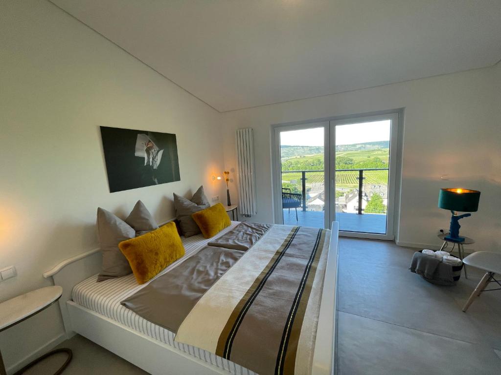 a bedroom with a large bed and a balcony at The View in Ensch