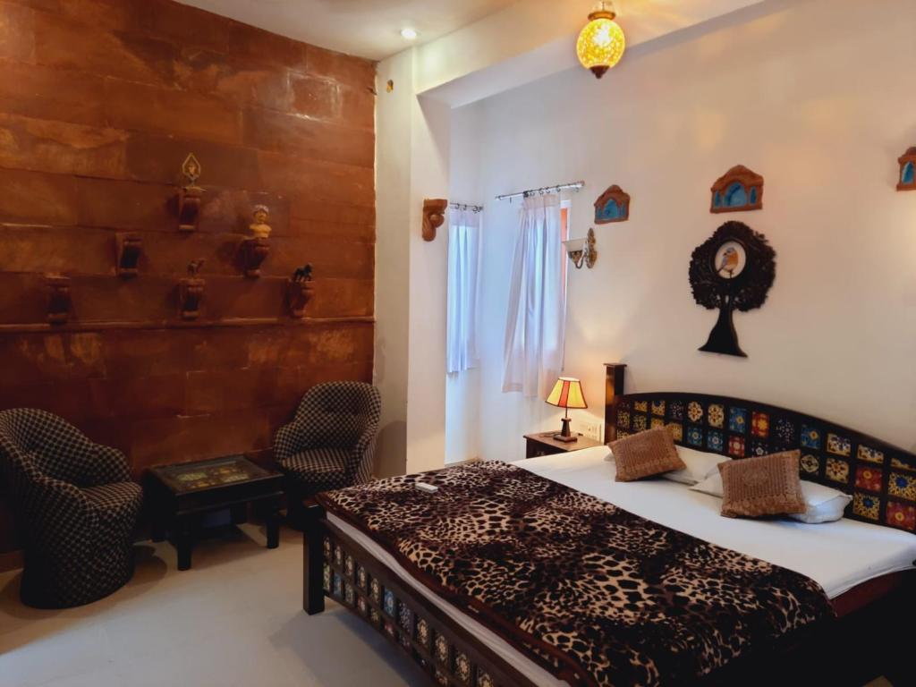 um quarto com uma cama, uma mesa e cadeiras em Karma homestay em Jodhpur