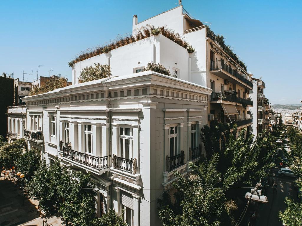 a white building with plants on the top of it at Athens Flair in Athens