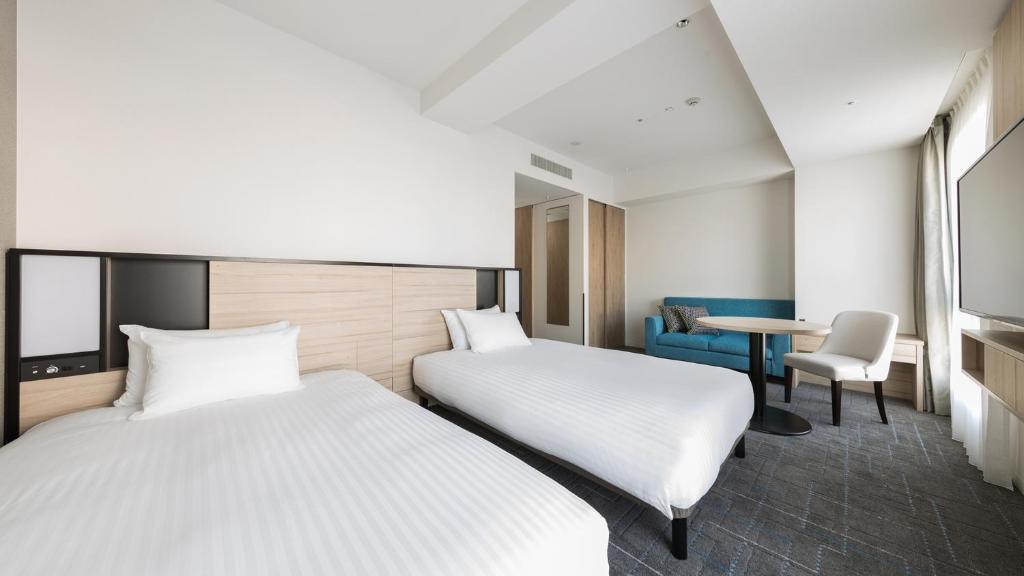 Postel nebo postele na pokoji v ubytování JR East Hotel Mets Premier Gotanda