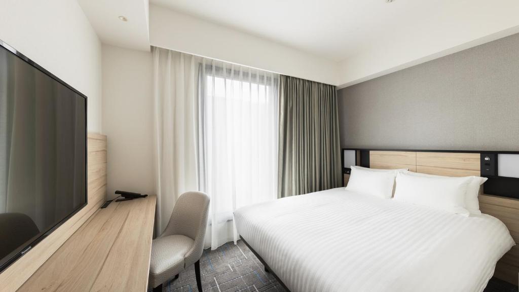 Postel nebo postele na pokoji v ubytování JR East Hotel Mets Premier Gotanda