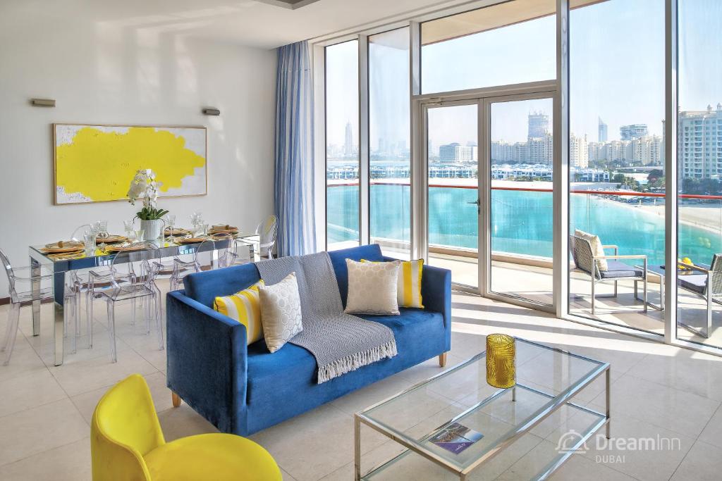 a living room with a blue couch and a table at Dream Inn Apartments - Tiara in Dubai