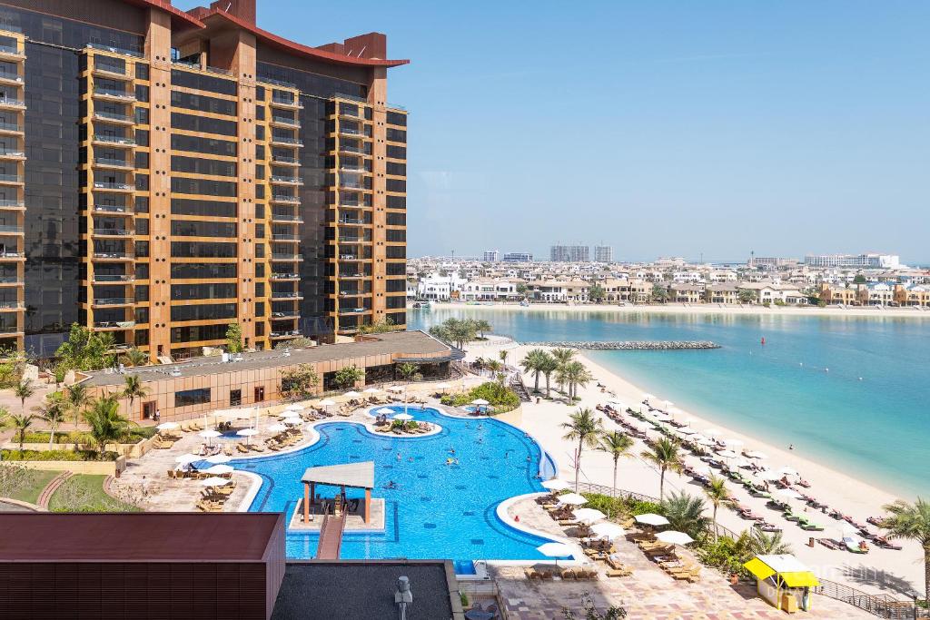 a view of a resort with a pool and a beach at Dream Inn Apartments - Tiara in Dubai