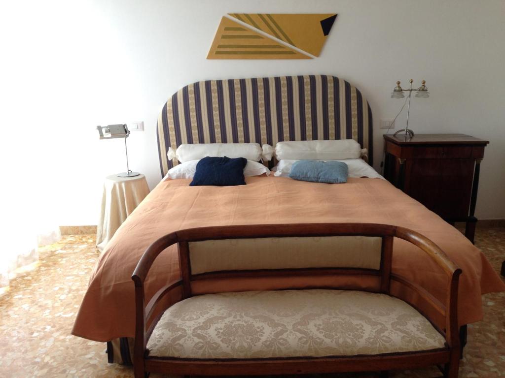 a bedroom with a large bed with two pillows at A Casa di Ilaria in Fermo
