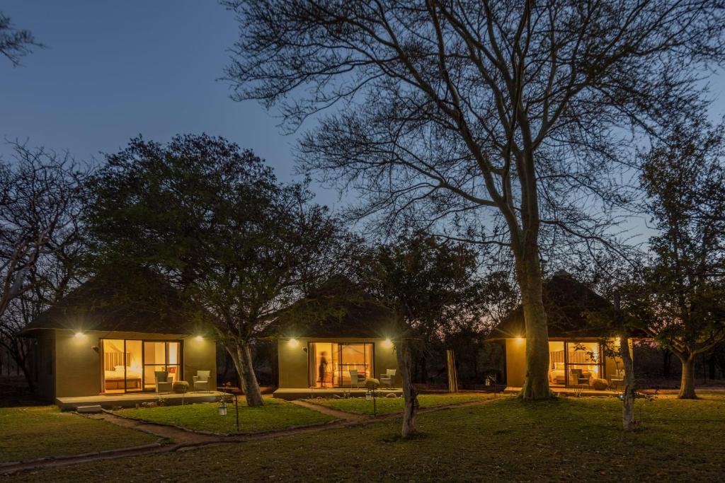 uma casa com luzes acesas num quintal à noite em Xanatseni Private Camp em Klaserie Private Nature Reserve