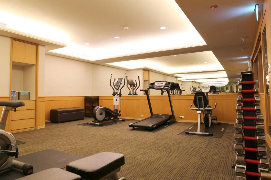 a gym with several exercise equipment in a room at Fuward Hotel Tainan in Tainan