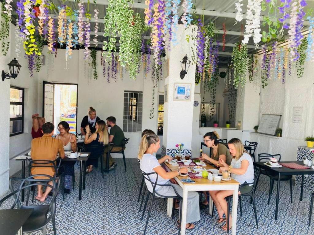 a group of people sitting at tables in a restaurant at Zaman Ya Zaman Boutique Hotel in Amman