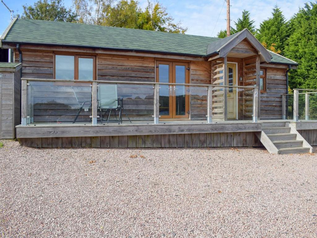 a log cabin with a porch and a patio at Lodge 2 in Kinlet