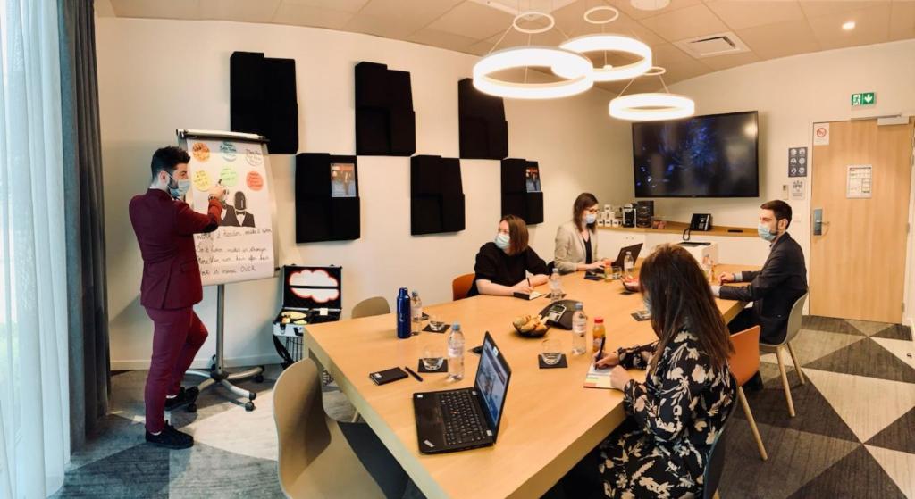 a group of people in a meeting room at Holiday Inn Express - Paris - CDG Airport by IHG in Roissy-en-France