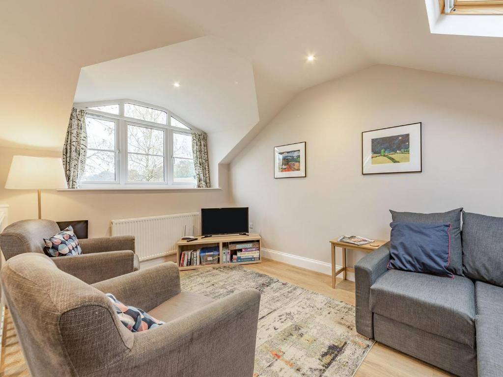 a living room with two couches and a tv at The Stables At Wells-in-the-field Farm in Whitchurch