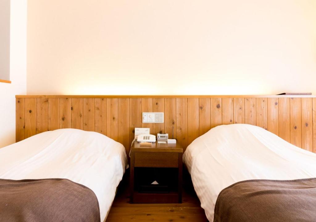 Postel nebo postele na pokoji v ubytování Yatsugatake Hotel Fuuka
