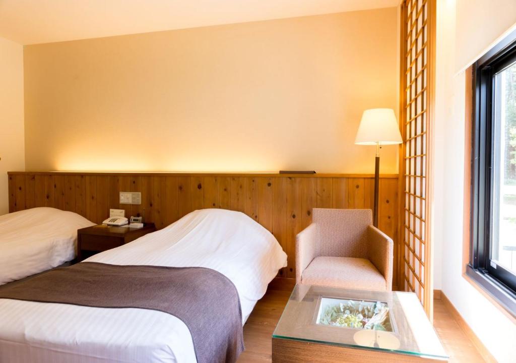 Postel nebo postele na pokoji v ubytování Yatsugatake Hotel Fuuka