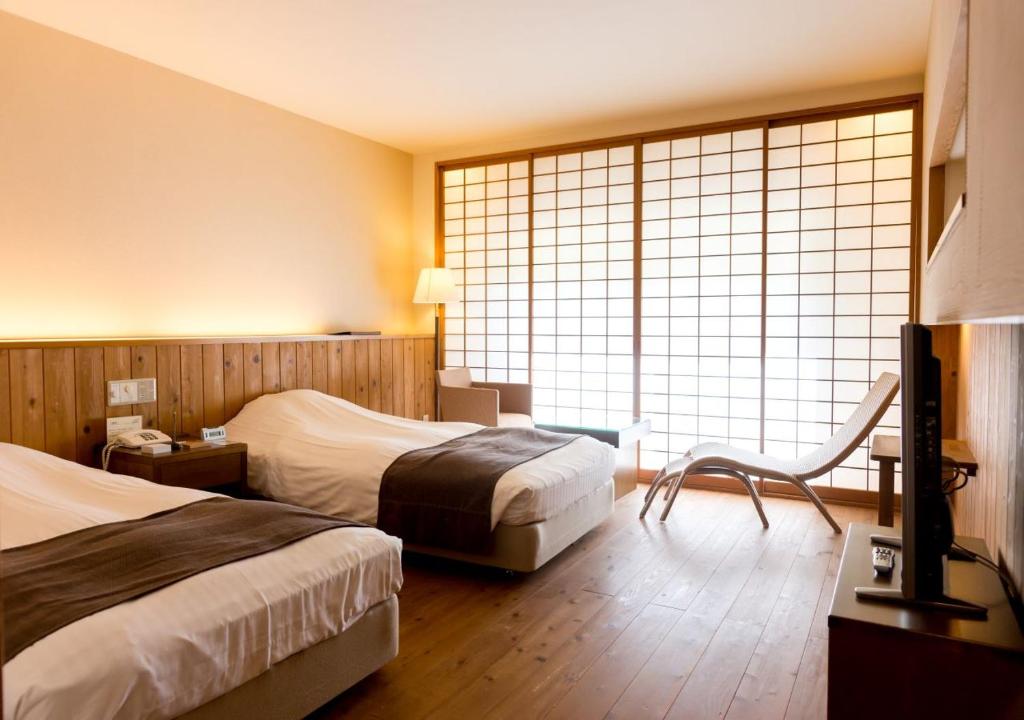 Postel nebo postele na pokoji v ubytování Yatsugatake Hotel Fuuka