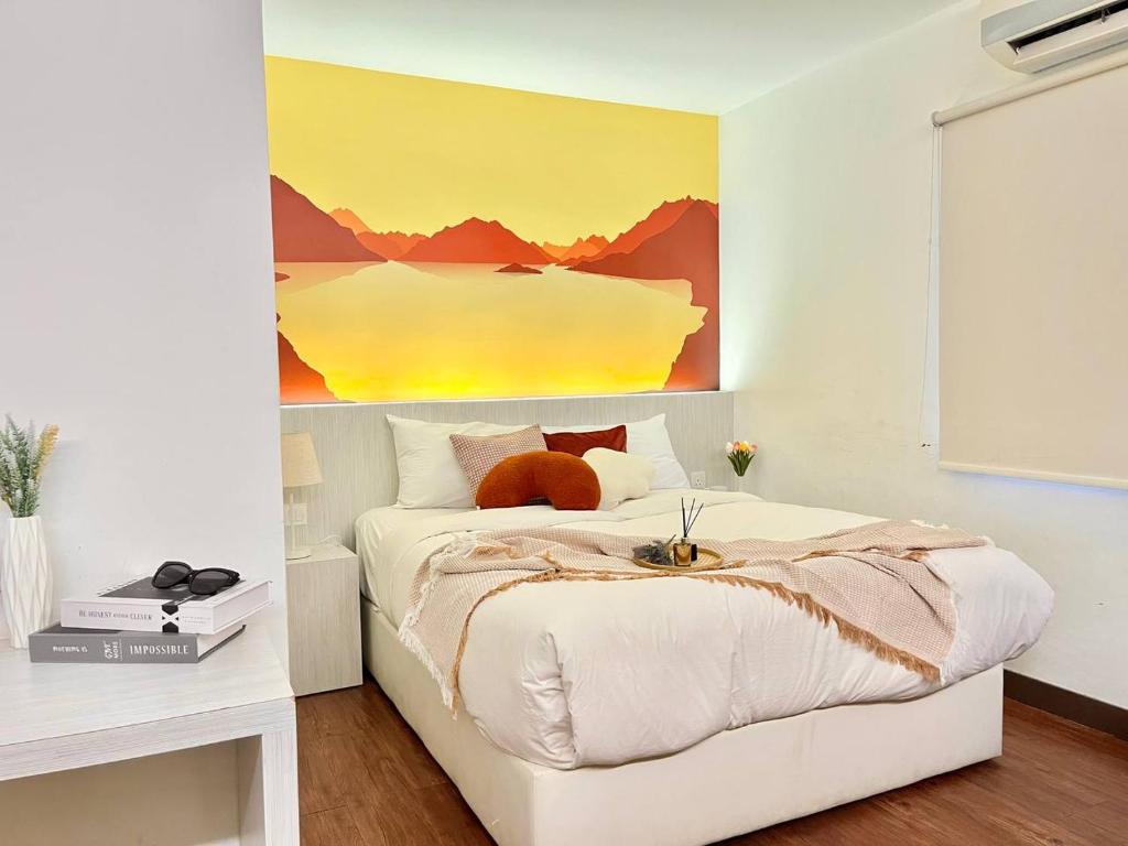 a bedroom with a bed with a painting on the wall at Swing & Pillows - KL Cheras Maluri in Kuala Lumpur