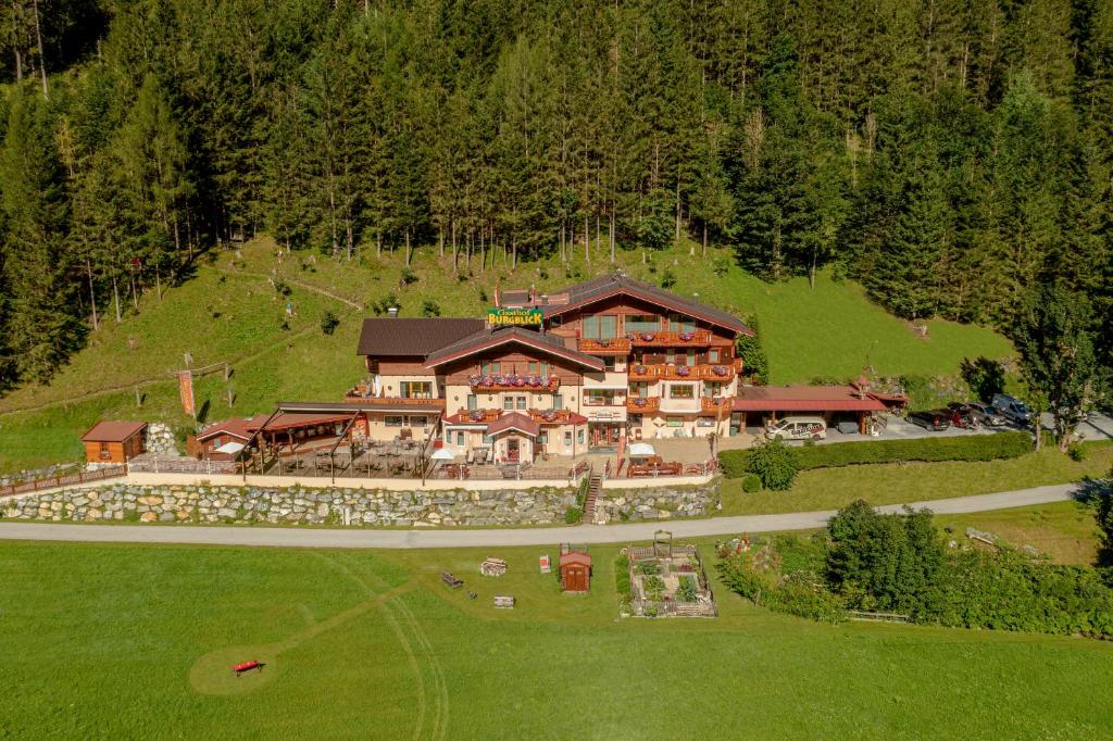 an aerial view of a large house on a hill at Hotel-Restaurant Burgblick in Dorfgastein
