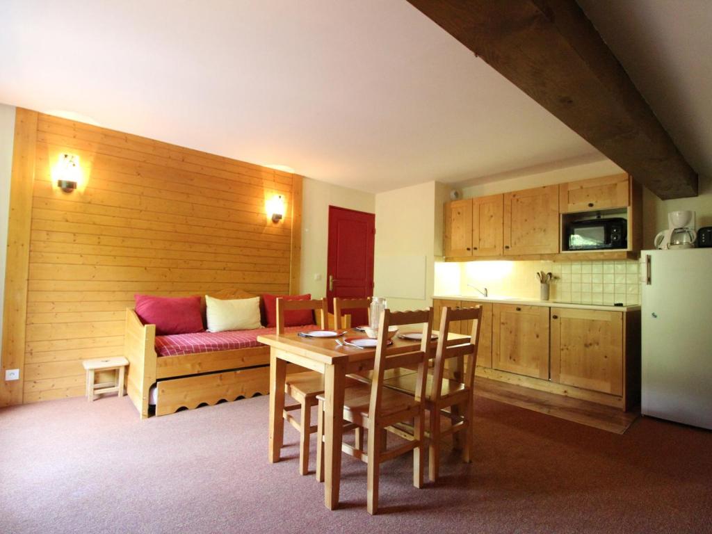 a kitchen and dining room with a table and a couch at Appartement Lanslebourg-Mont-Cenis, 2 pièces, 4 personnes - FR-1-508-132 in Lanslebourg-Mont-Cenis