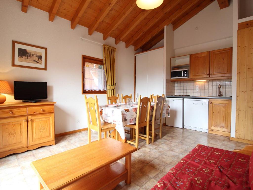 a kitchen and dining room with a table and chairs at Appartement Lanslevillard, 3 pièces, 6 personnes - FR-1-508-81 in Lanslevillard