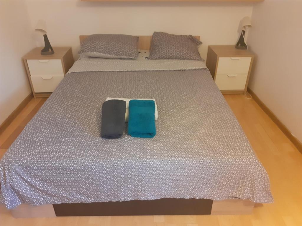 a bedroom with a large bed with two night stands at Happy central Bucharest acomodation in Bucharest