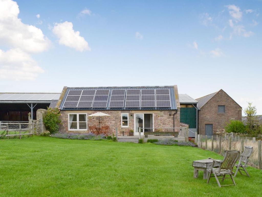 a house with a lot of solar panels on it at Little Barn Tynely Farm in Ellingham