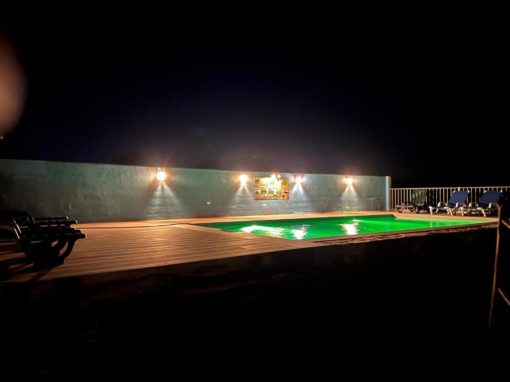 an empty swimming pool at night with lights at Casa da Eira in Reguengos de Monsaraz