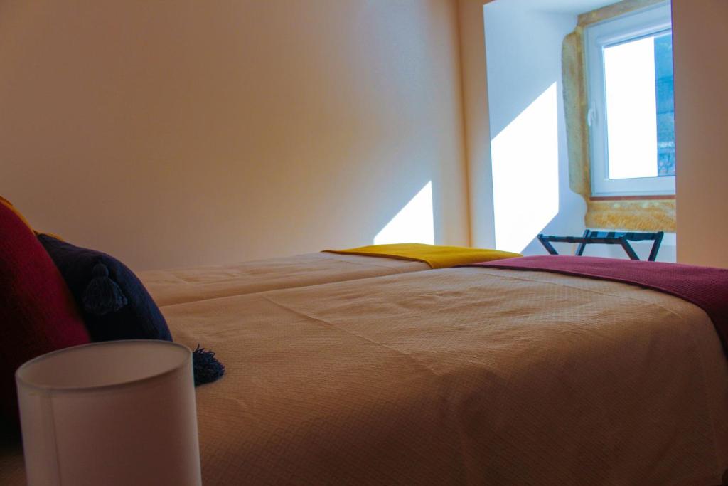Uma cama ou camas num quarto em Casa de Campo Vale do Ceira