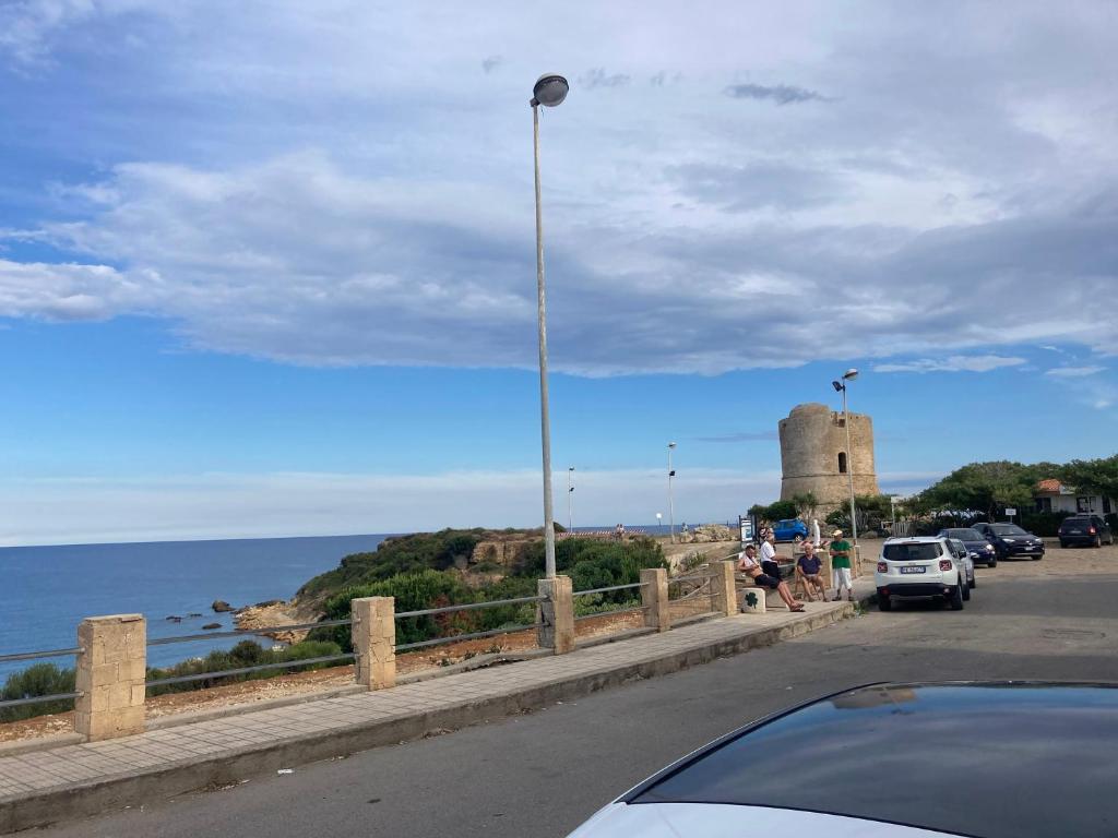 a car parked on a road next to the ocean at Appartamento smart con splendido mare sotto casa in Capo Rizzuto